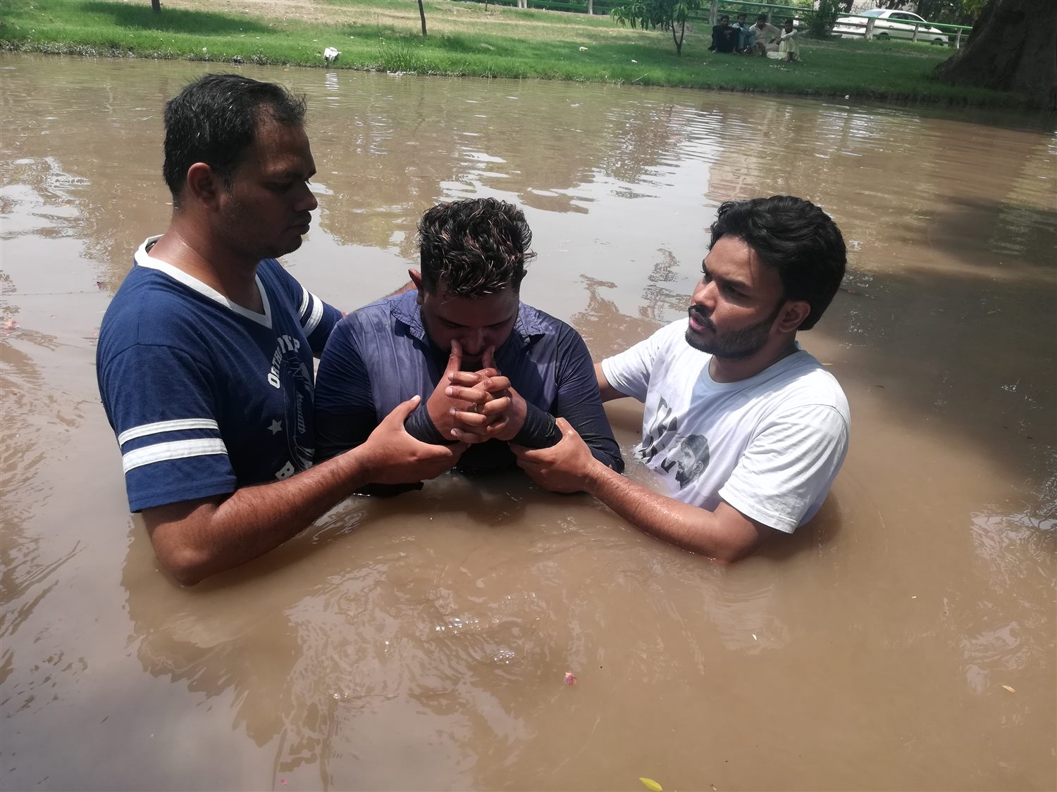 A baptism service in an outdoor river