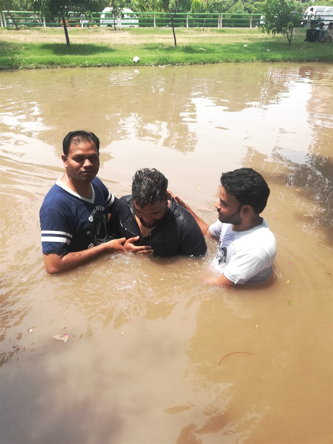 A man being baptized during an outdoor service