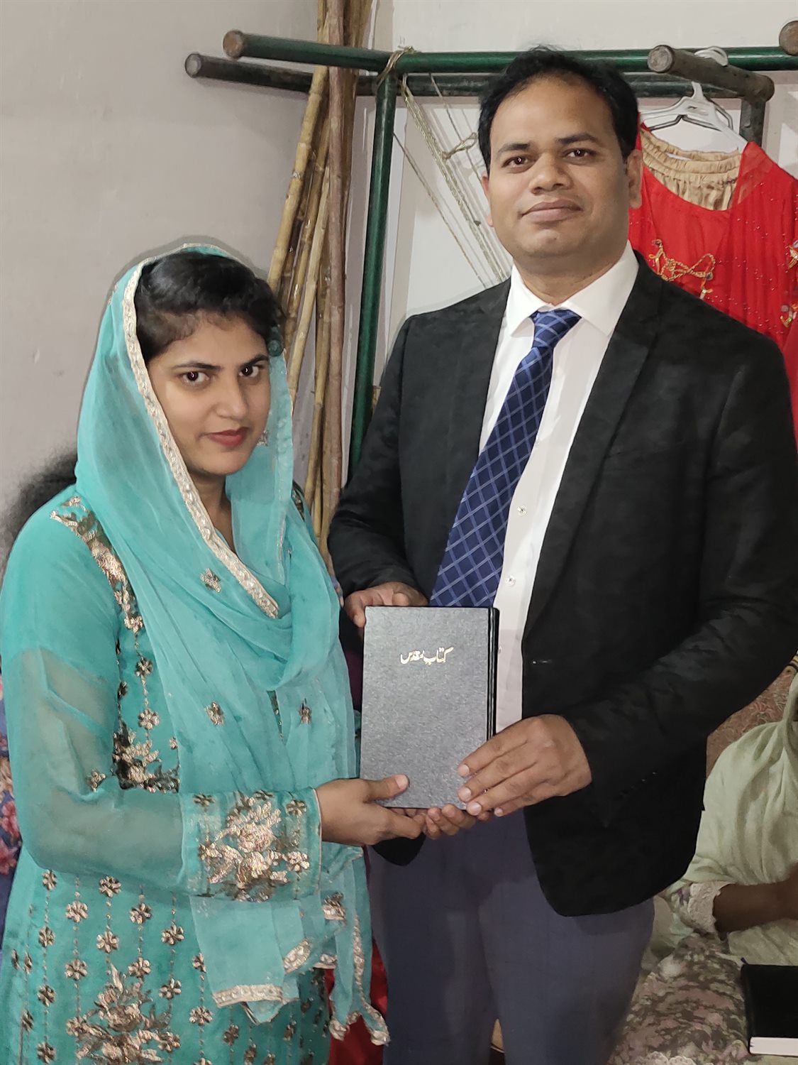 A woman receiving a Bible during a ministry visit