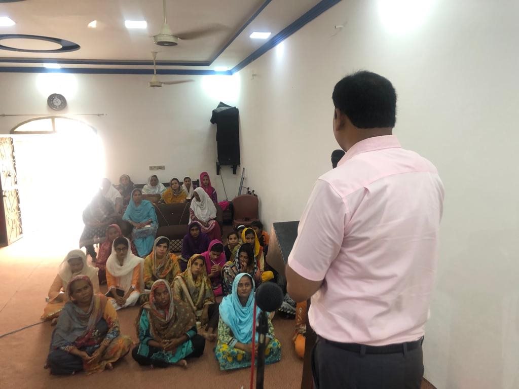 A speaker teaching a group of women