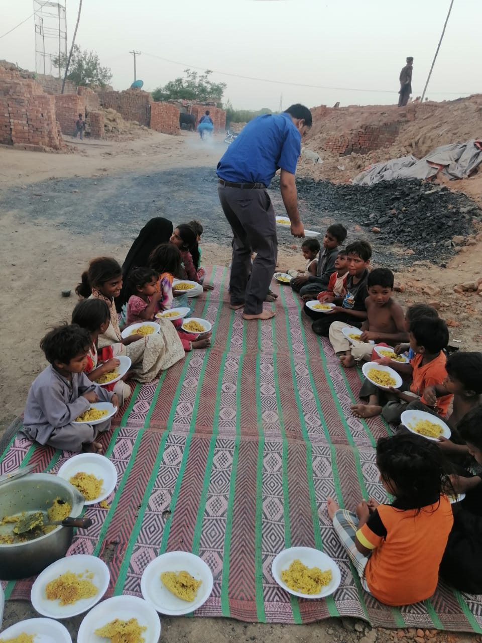 A ministry volunteer serving food to children