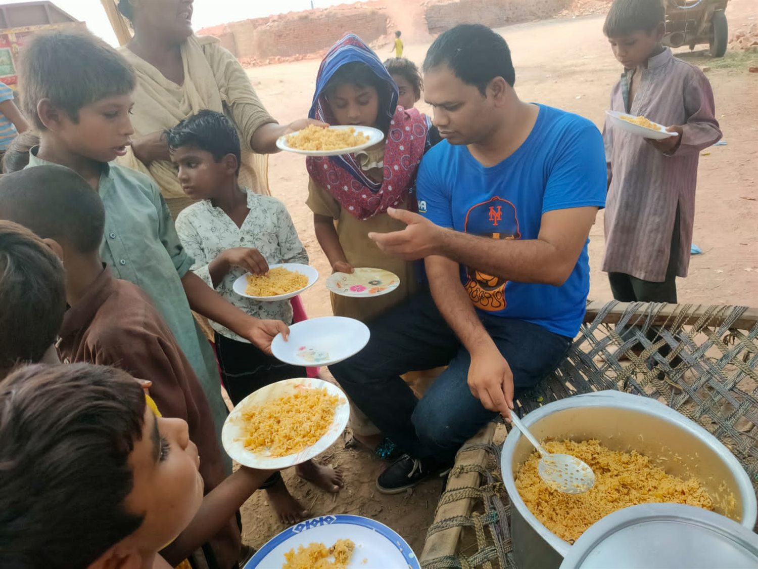 Volunteers serving food to children