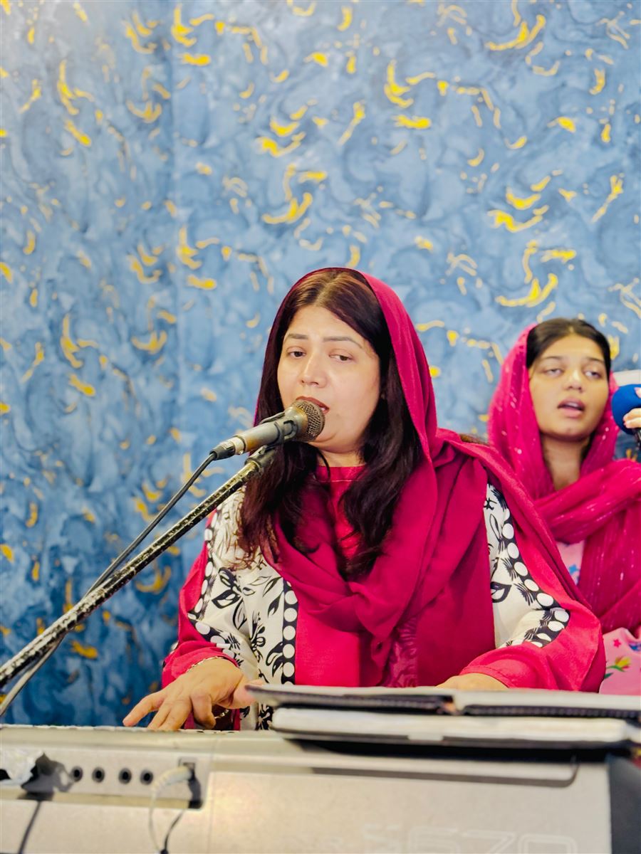 A woman leading worship with a microphone