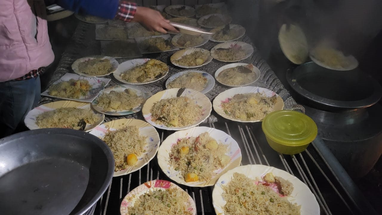 Volunteers preparing meals for distribution
