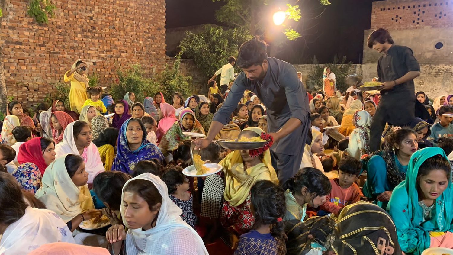 People sharing a meal at an outdoor gathering
