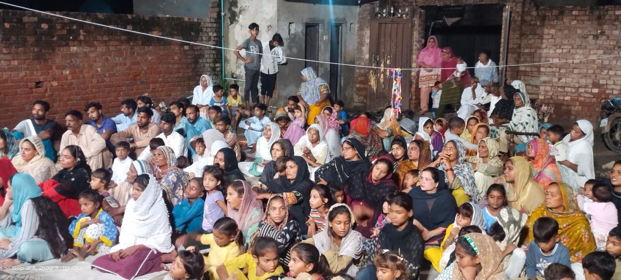 A large community meeting during an outreach
