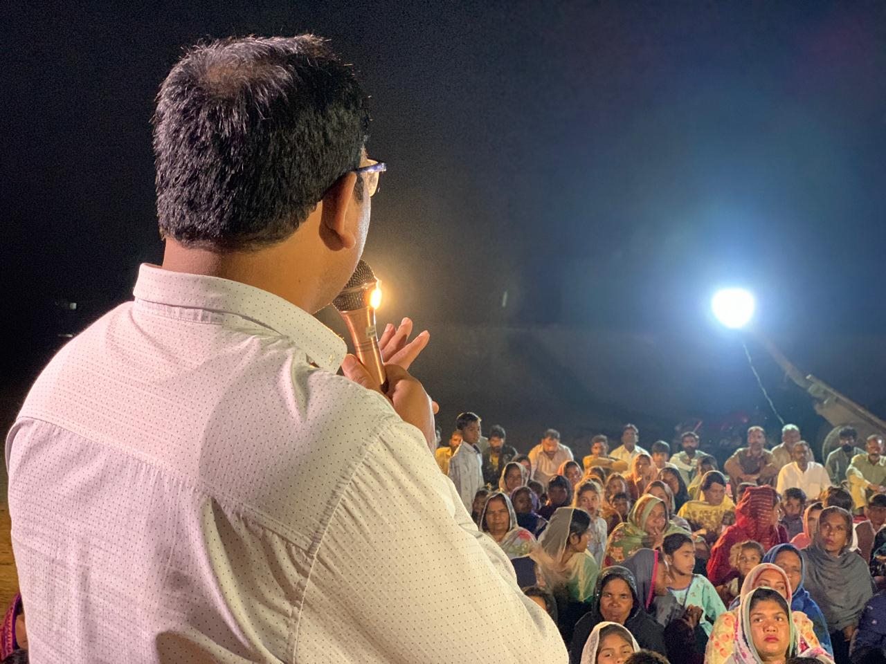 A ministry speaker addressing an outdoor gathering