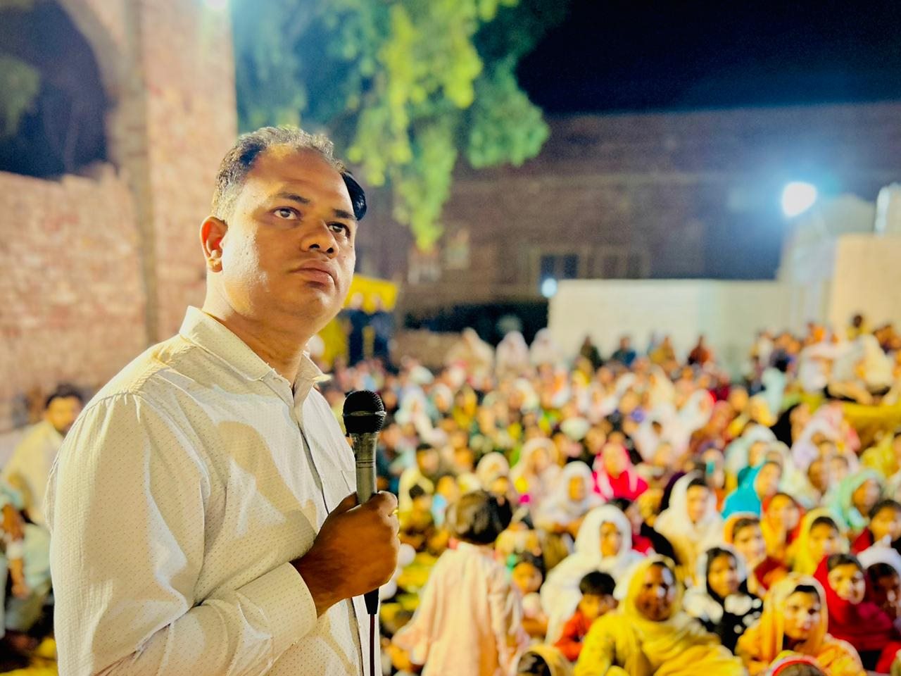 A speaker sharing the Gospel with a crowd