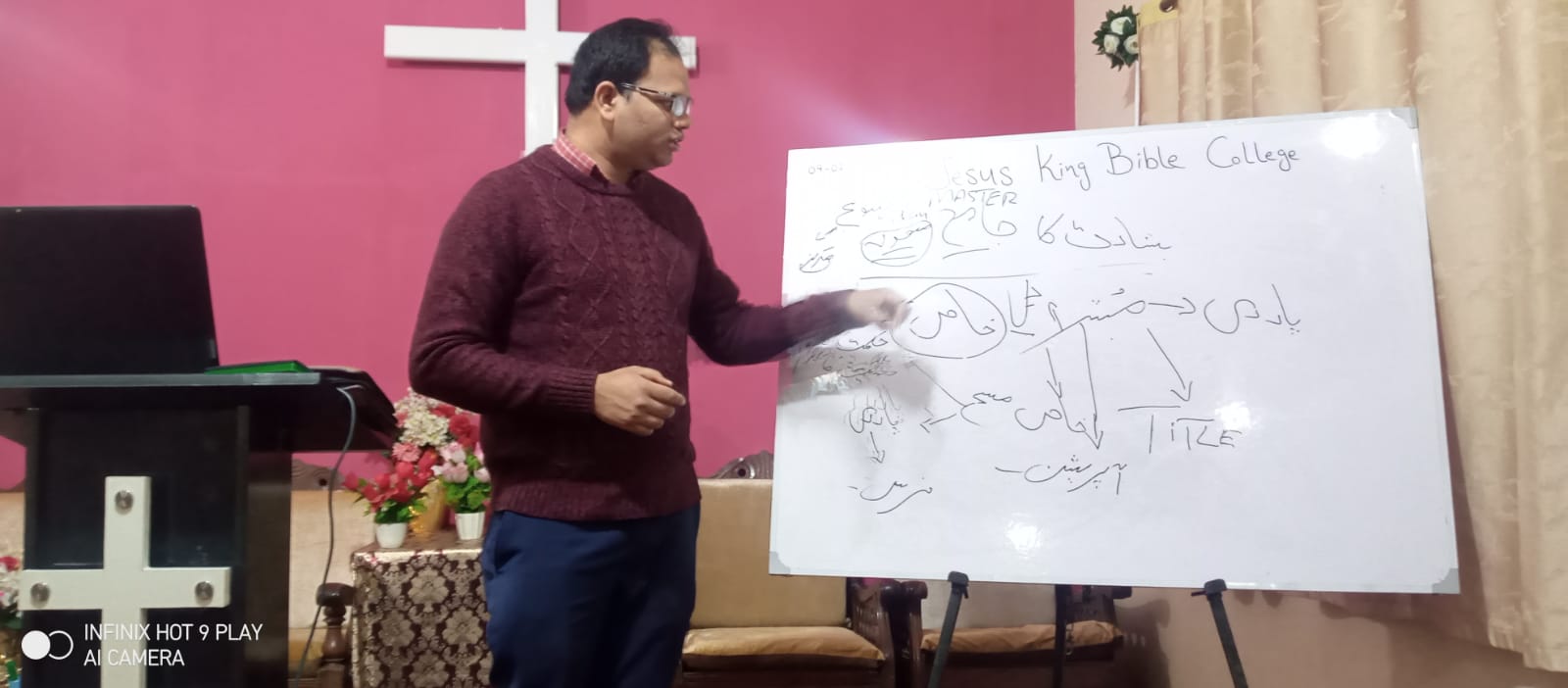 A ministry teacher leading a lesson at a whiteboard